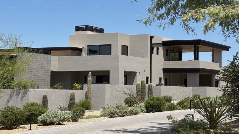 Large modern Arizona home with saguaro cacti representing home equity loan vs HELOC comparison for high-value properties